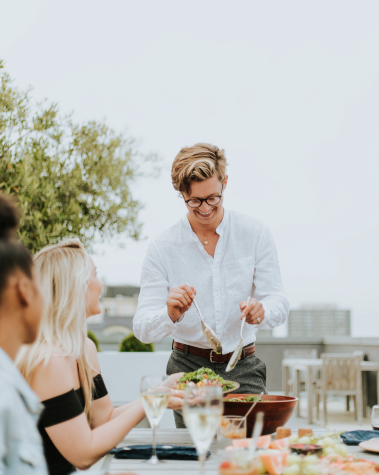Stock photo of woman serving food outdoors